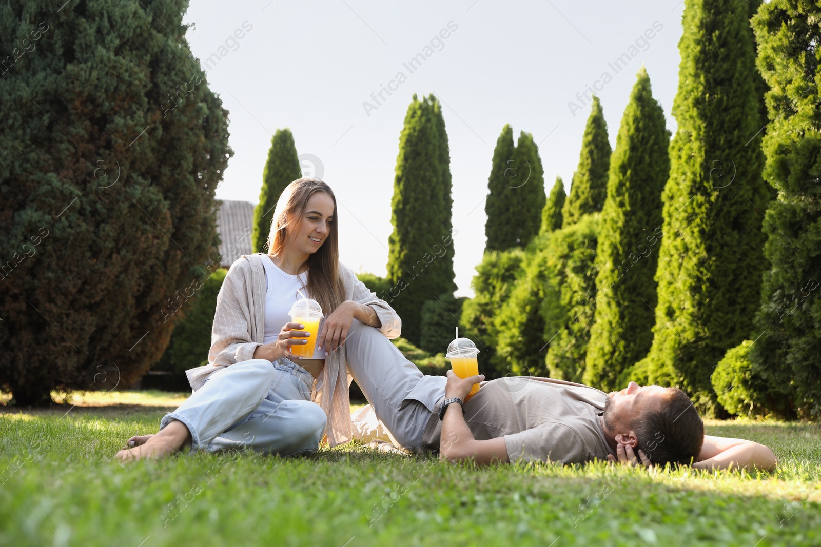 Photo of Couple spending time together on green lawn in park