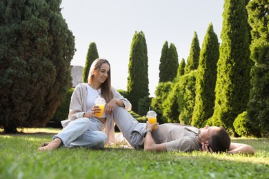 Couple spending time together on green lawn in park