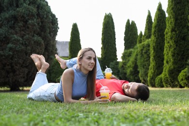 Couple spending time together on green lawn in park