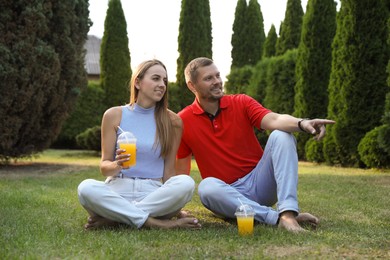 Couple spending time together on green lawn in park