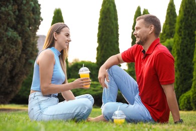 Couple spending time together on green lawn in park