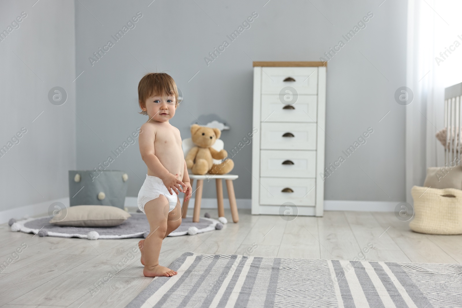 Photo of Cute little child in diaper at home