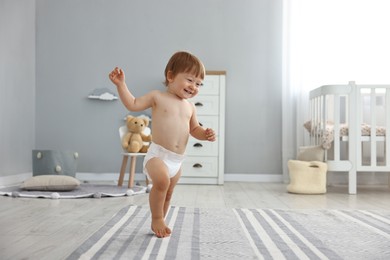 Cute little child in diaper at home