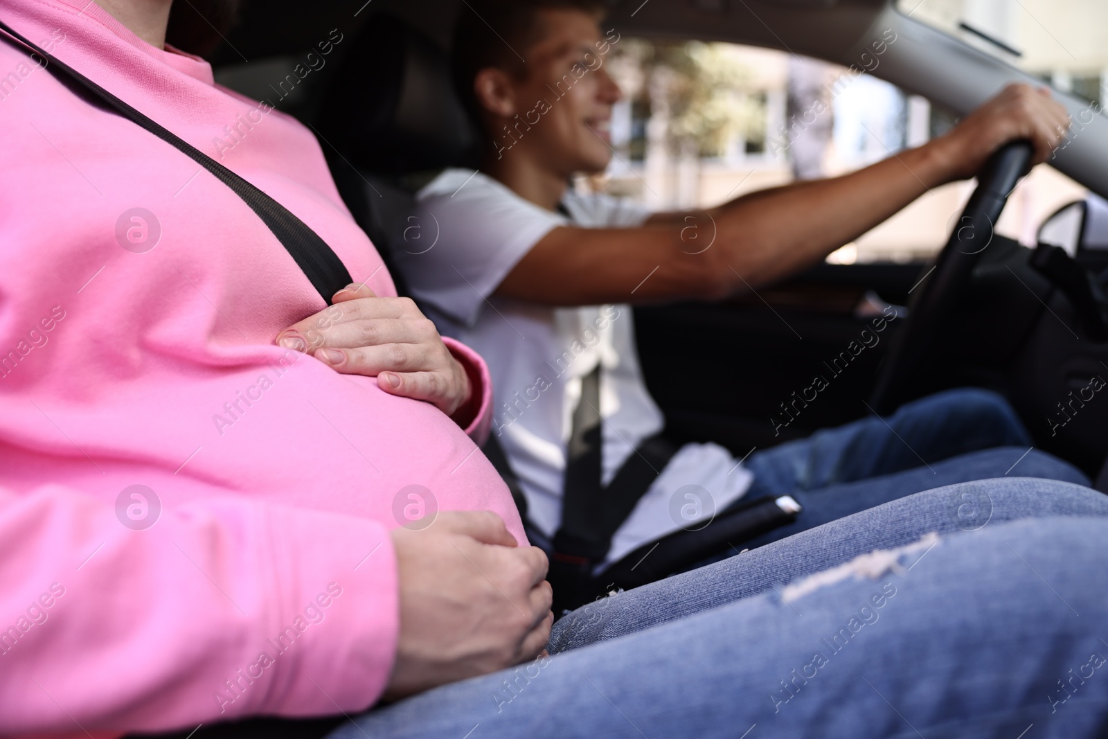 Photo of Pregnant woman travelling with her husband by car, closeup