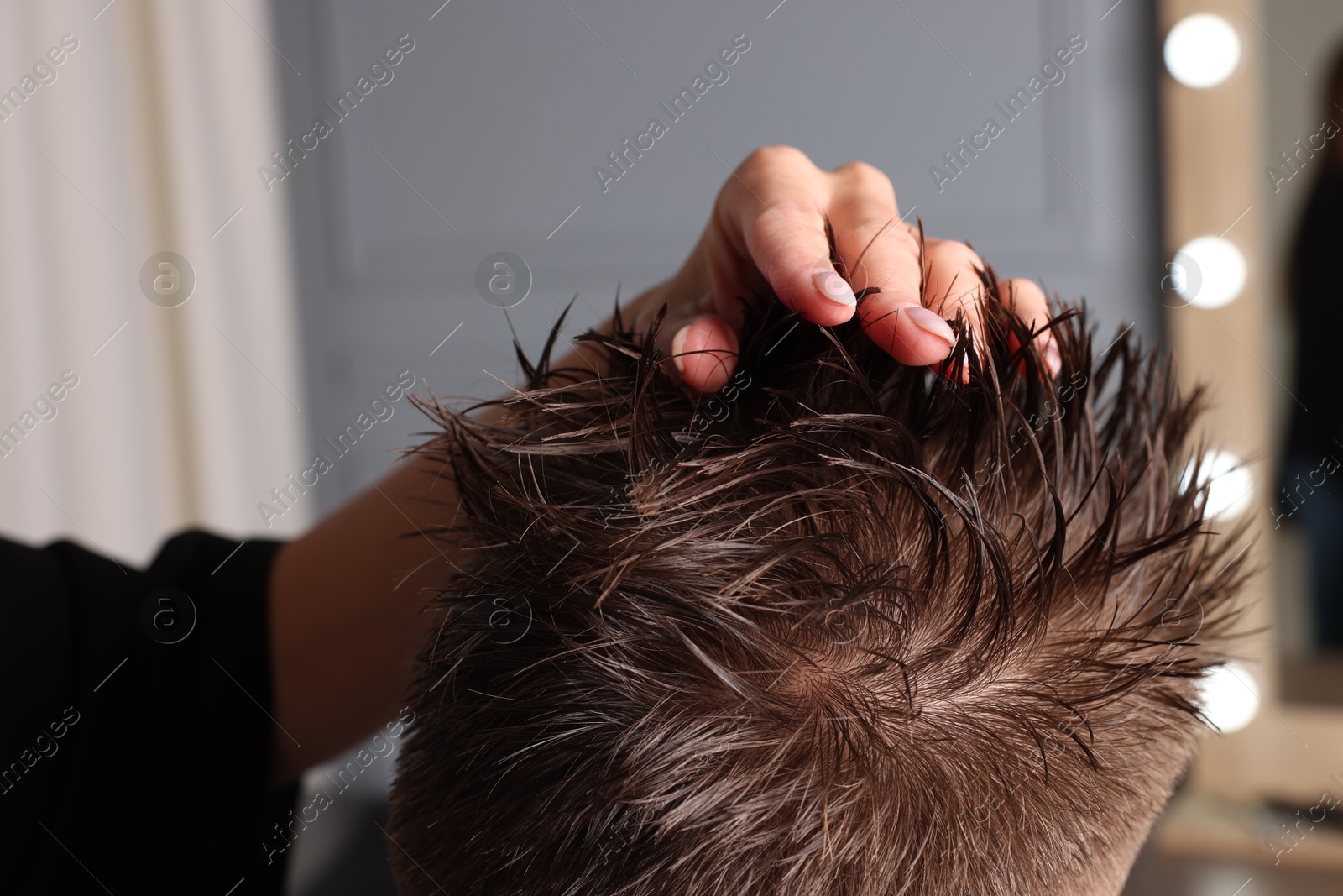 Photo of Hair cutting. Professional hairdresser working with client in barbershop, closeup