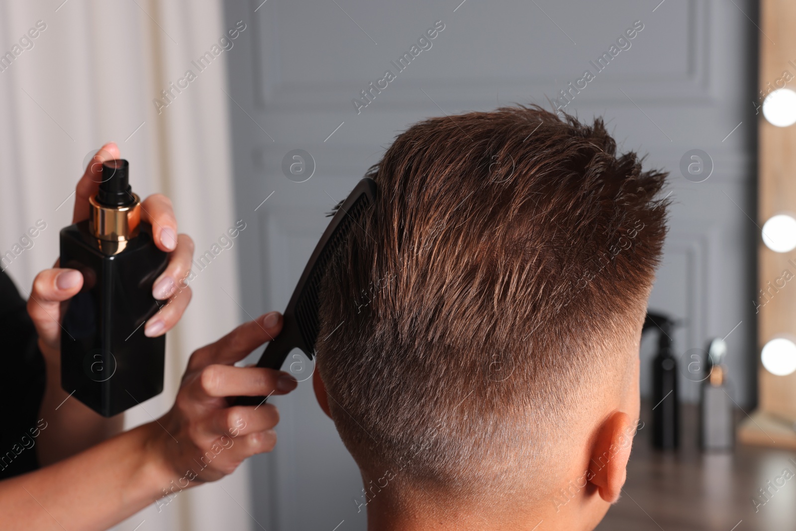 Photo of Hair cutting. Professional hairdresser working with client in barbershop, closeup