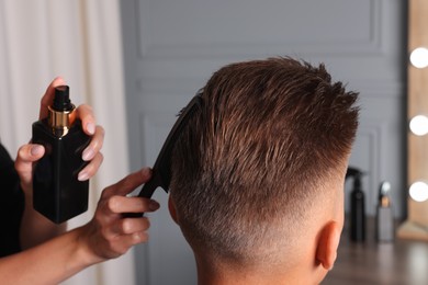 Hair cutting. Professional hairdresser working with client in barbershop, closeup