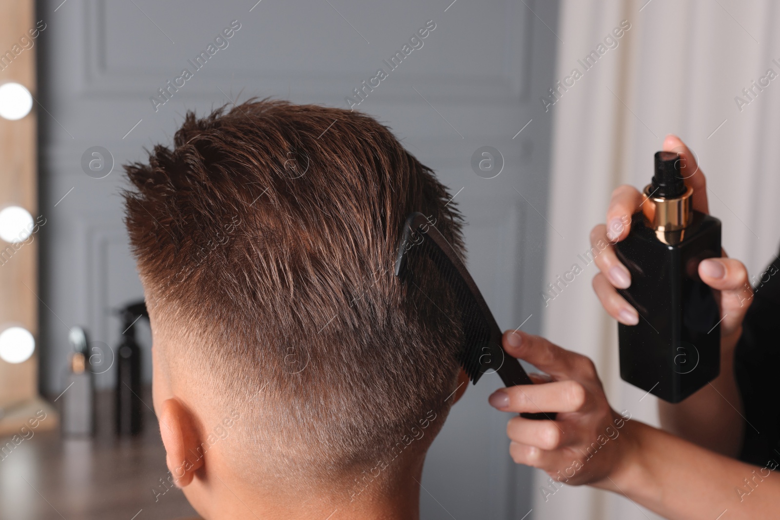 Photo of Hair cutting. Professional hairdresser working with client in barbershop, closeup