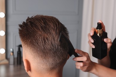 Hair cutting. Professional hairdresser working with client in barbershop, closeup