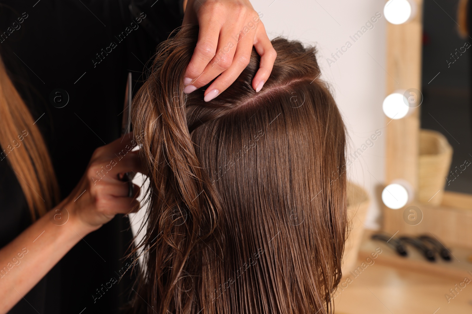 Photo of Hair cutting. Professional hairdresser working with client in salon, closeup