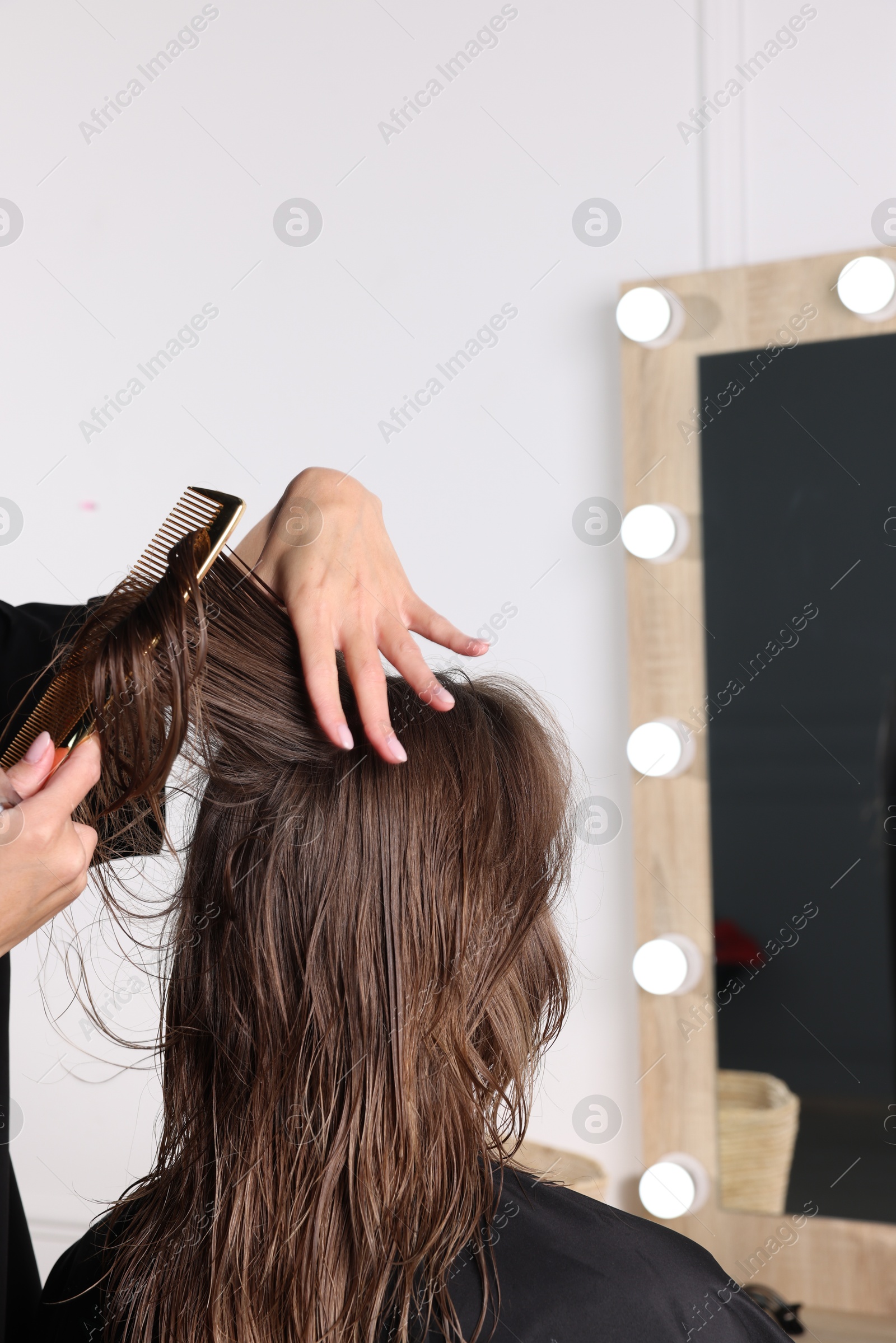 Photo of Hair cutting. Professional hairdresser working with client in salon, closeup