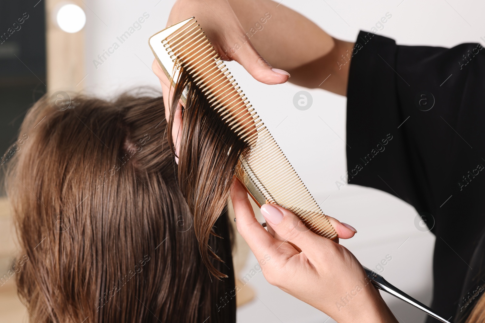 Photo of Hair cutting. Professional hairdresser working with client in salon, closeup