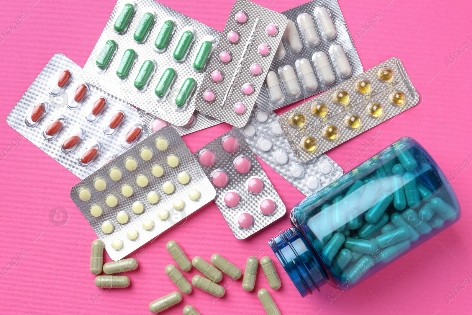 Photo of Pharmacist concept. Flat lay composition with many different pills on pink background