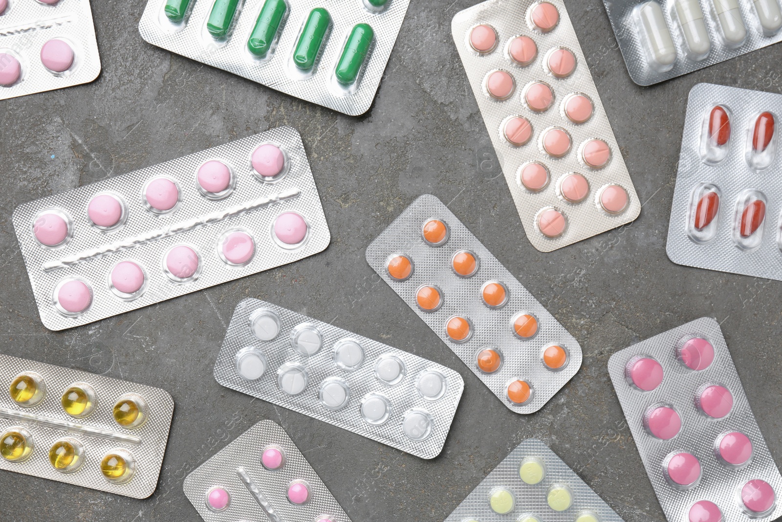 Photo of Pharmacist. Many different pills on grey table, flat lay