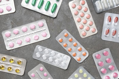 Photo of Pharmacist. Many different pills on grey table, flat lay