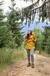 Young hiker with backpack in forest. Active tourism