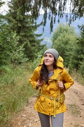 Young hiker with backpack in forest. Active tourism