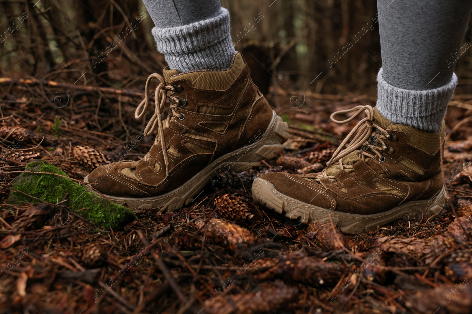 Photo of Hiker with trekking shoes in forest, closeup