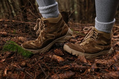 Photo of Hiker with trekking shoes in forest, closeup