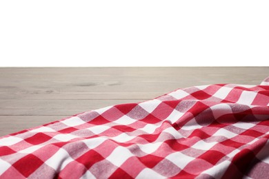 Photo of Crumpled tablecloth with checkered pattern on wooden table against white background