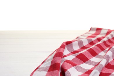 Photo of Crumpled tablecloth with checkered pattern on wooden table against white background