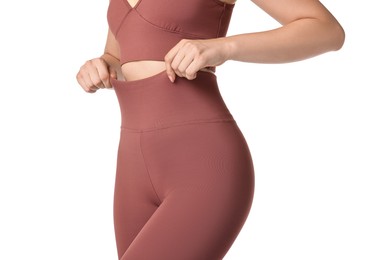 Photo of Woman wearing sports leggings and bra on white background, closeup