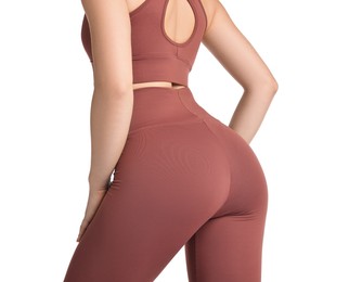 Photo of Woman wearing sports leggings and bra on white background, closeup