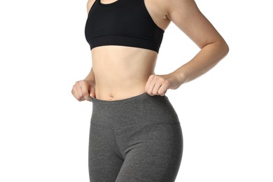 Photo of Woman wearing sports leggings and bra on white background, closeup