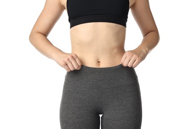 Woman wearing sports leggings and bra on white background, closeup