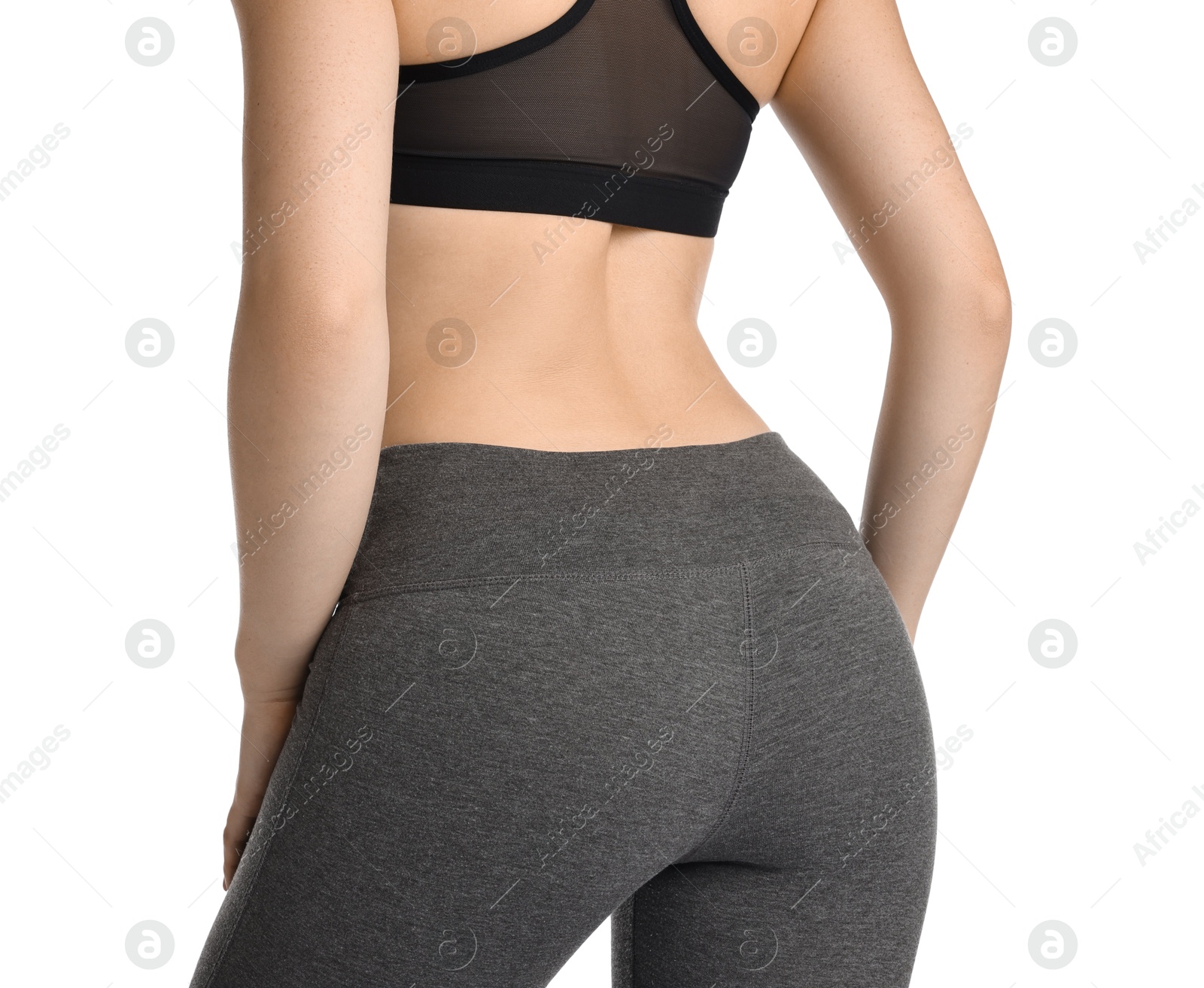 Photo of Woman wearing sports leggings and bra on white background, closeup