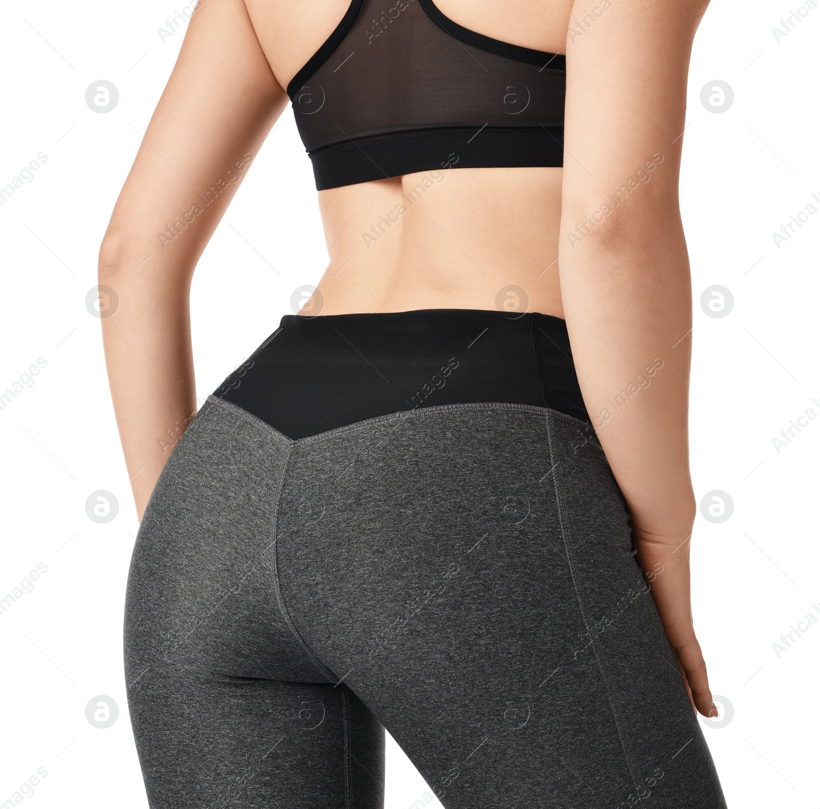 Photo of Woman wearing sports leggings and bra on white background, closeup