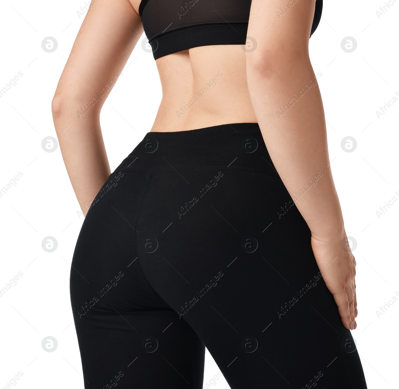 Photo of Woman wearing black sports leggings and bra on white background, closeup