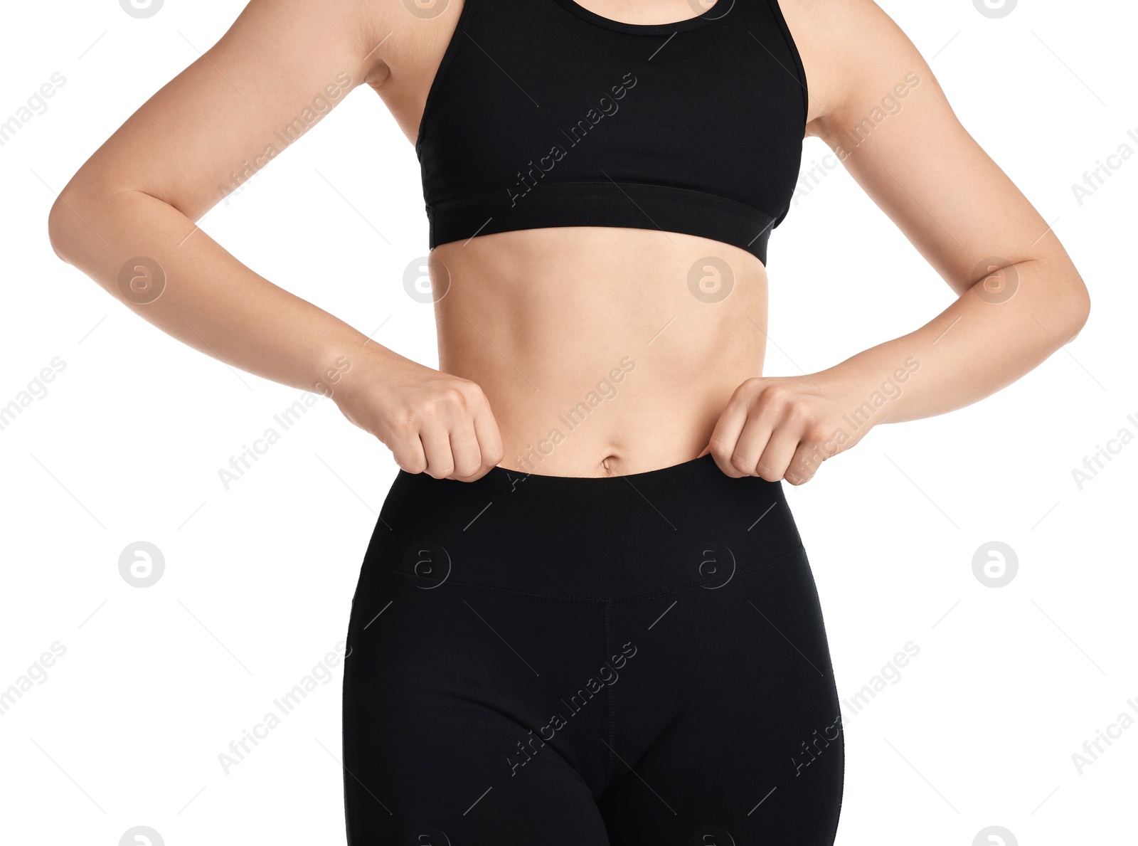 Photo of Woman wearing black sports leggings and bra on white background, closeup