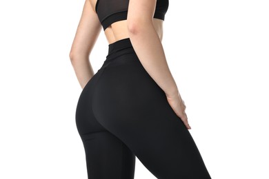 Woman wearing black sports leggings on white background, closeup