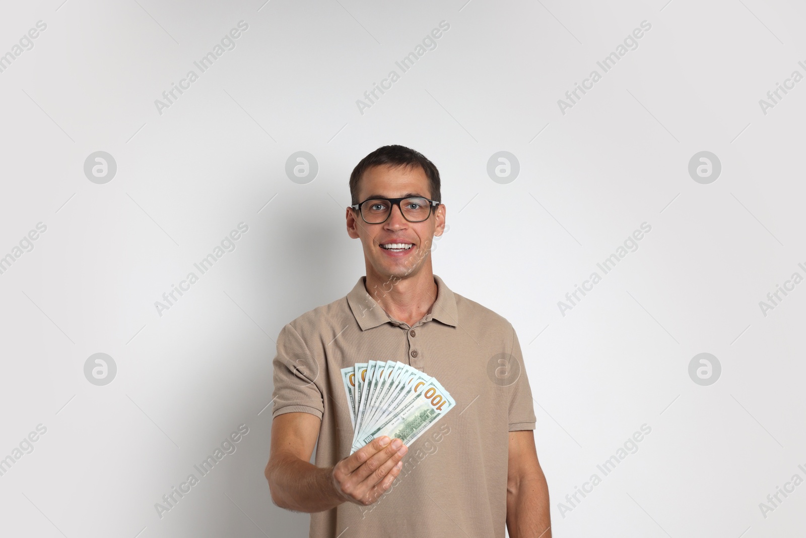 Photo of Man with dollar banknotes on white background