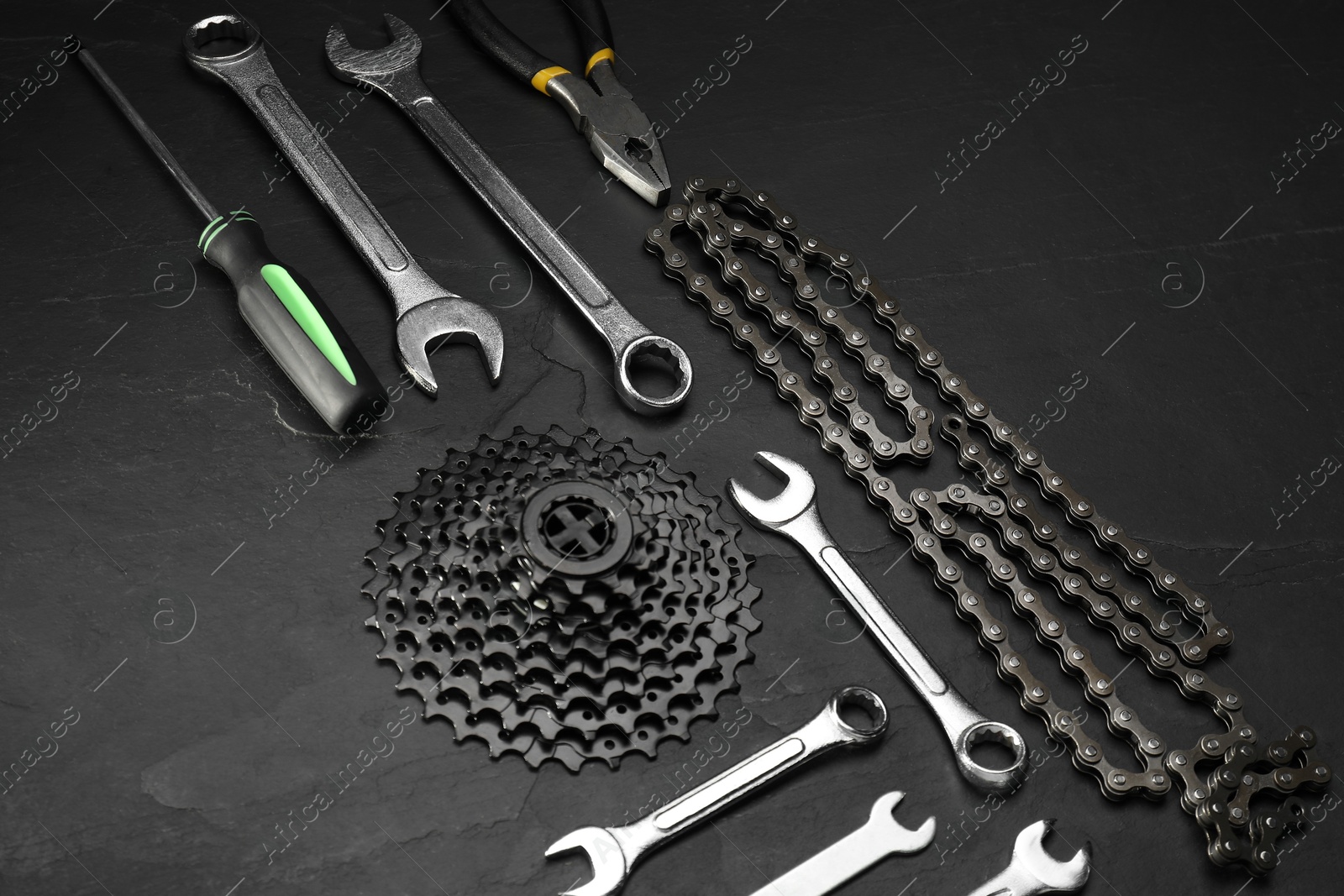 Photo of Parts of bicycle and tools on black table