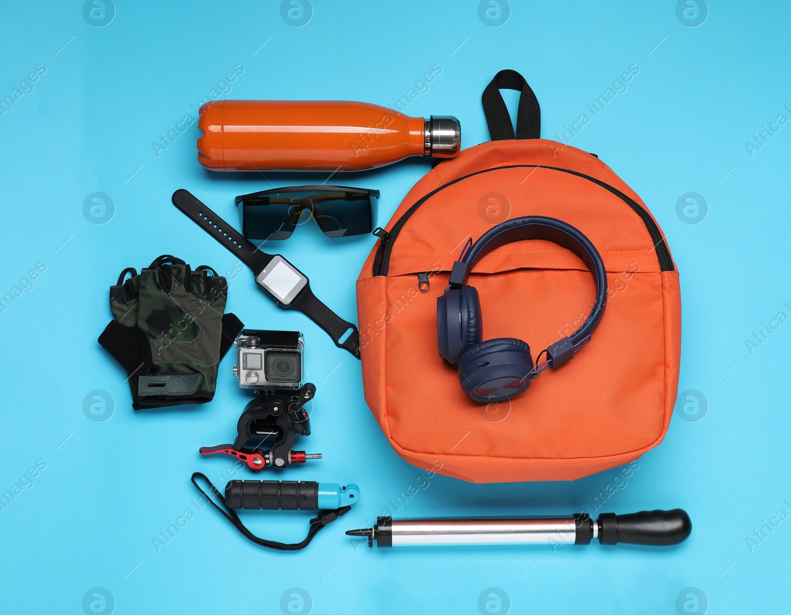 Photo of Flat lay composition with bicycle accessories on light blue background