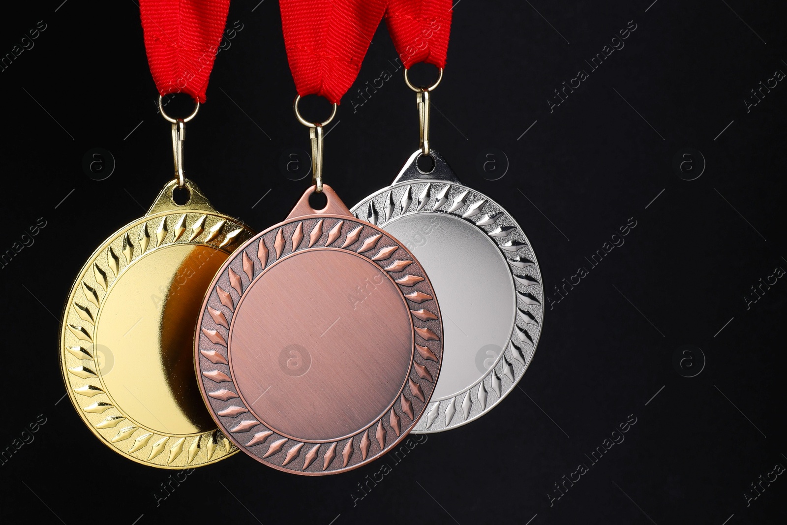 Photo of Golden, silver and bronze medals on black background