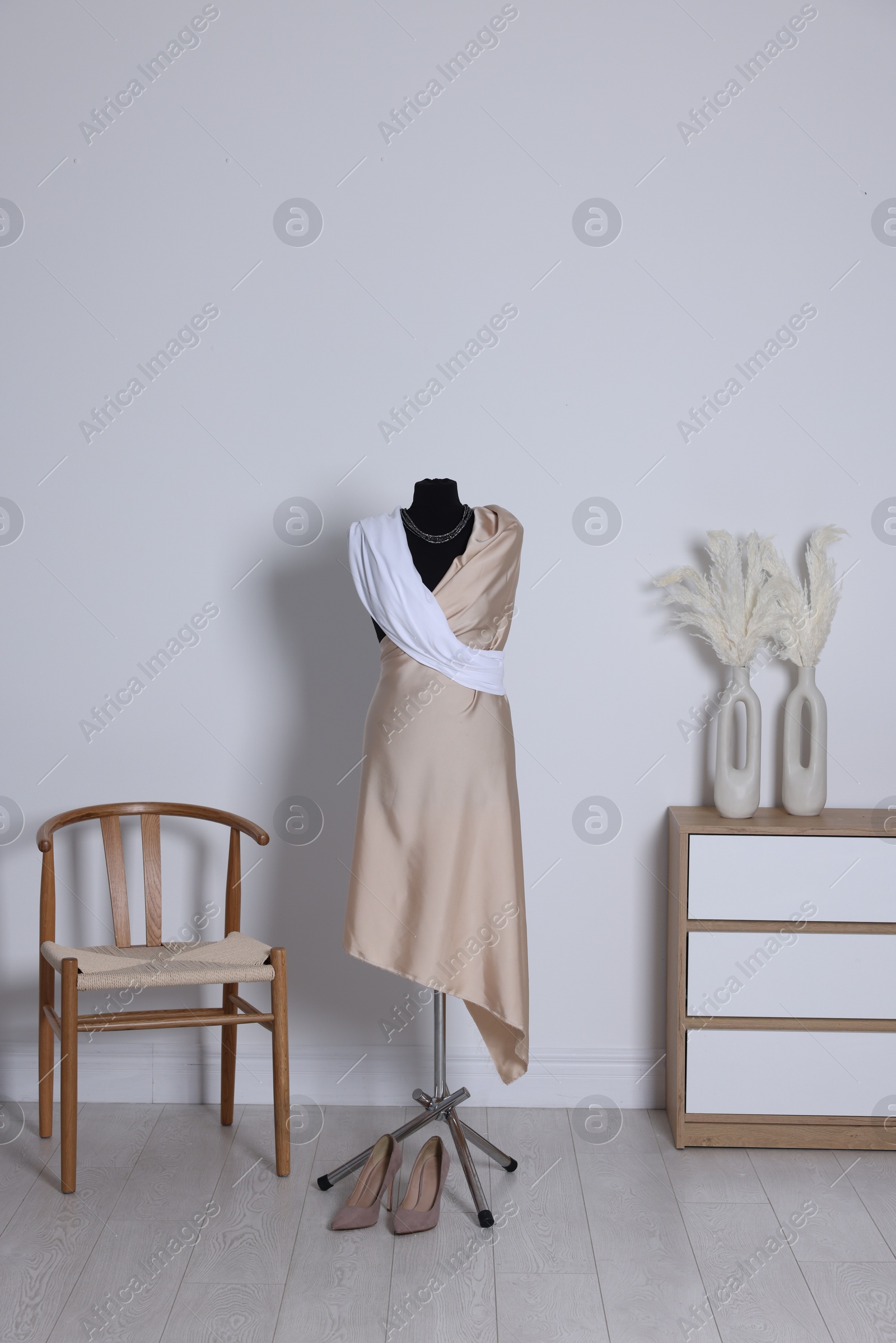 Photo of Female mannequin with draping and shoes in designer's workshop