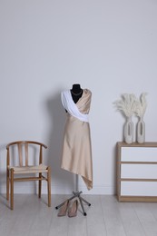 Female mannequin with draping and shoes in designer's workshop