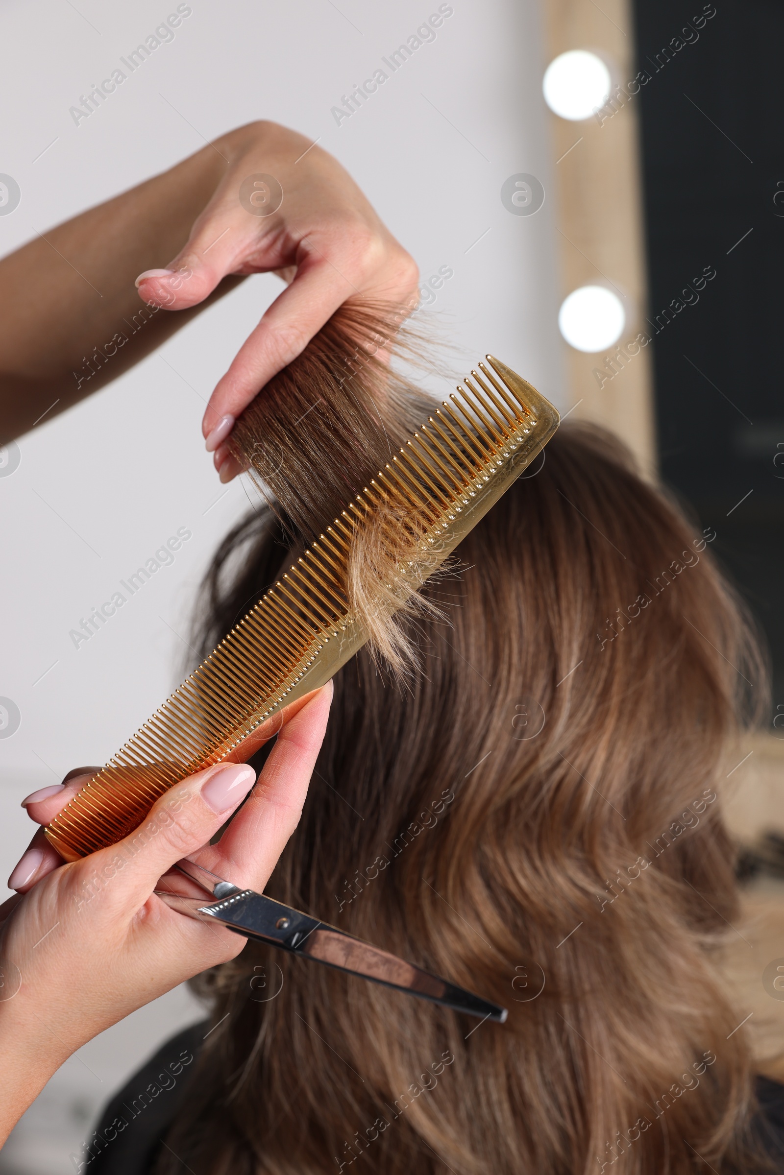 Photo of Hair cutting. Professional hairdresser working with client in salon, closeup