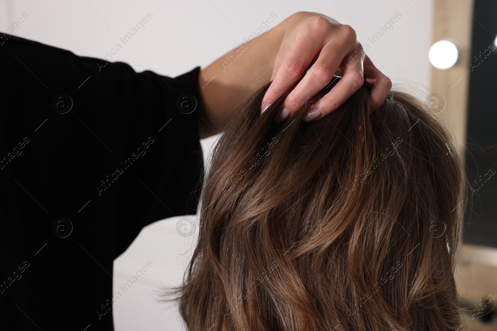 Photo of Hair cutting. Professional hairdresser working with client in salon, closeup