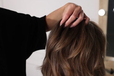 Hair cutting. Professional hairdresser working with client in salon, closeup