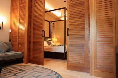 Photo of Stylish wooden sliding doors in hotel room