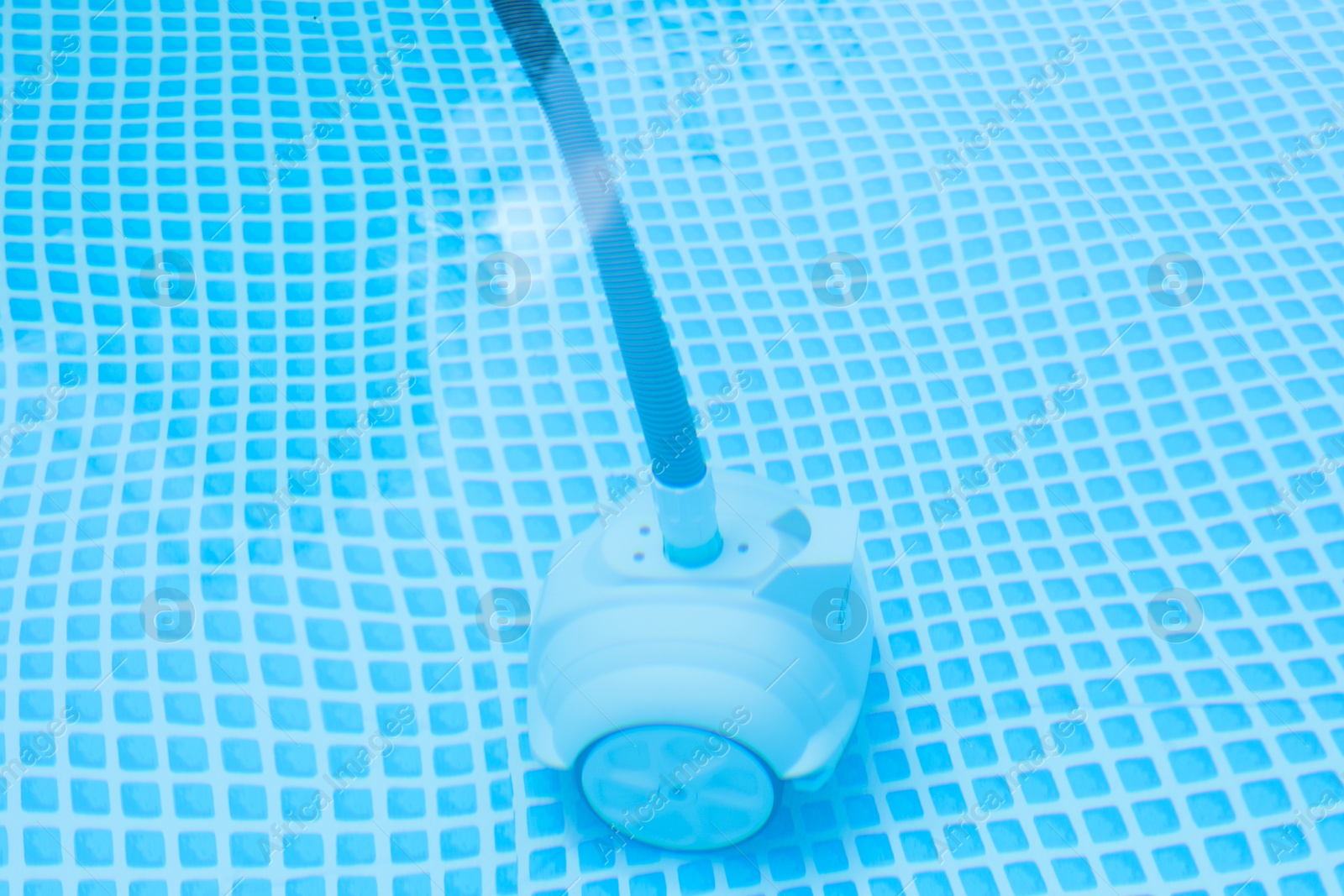 Photo of One robotic cleaner in swimming pool outdoors