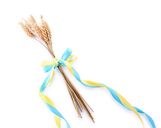 Ears of wheat with ribbons in colors of Ukrainian national flag isolated on white, above view