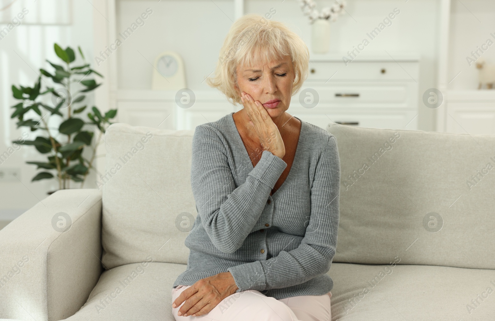 Photo of Beautiful senior woman suffering from headache at home