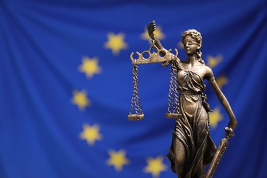 Figure of Lady Justice against European Union flag, closeup. Space for text