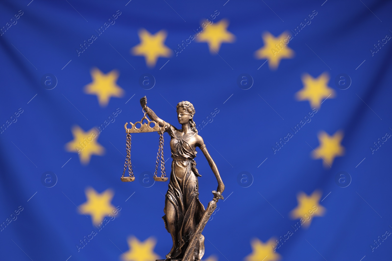 Photo of Figure of Lady Justice against European Union flag