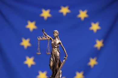 Figure of Lady Justice against European Union flag